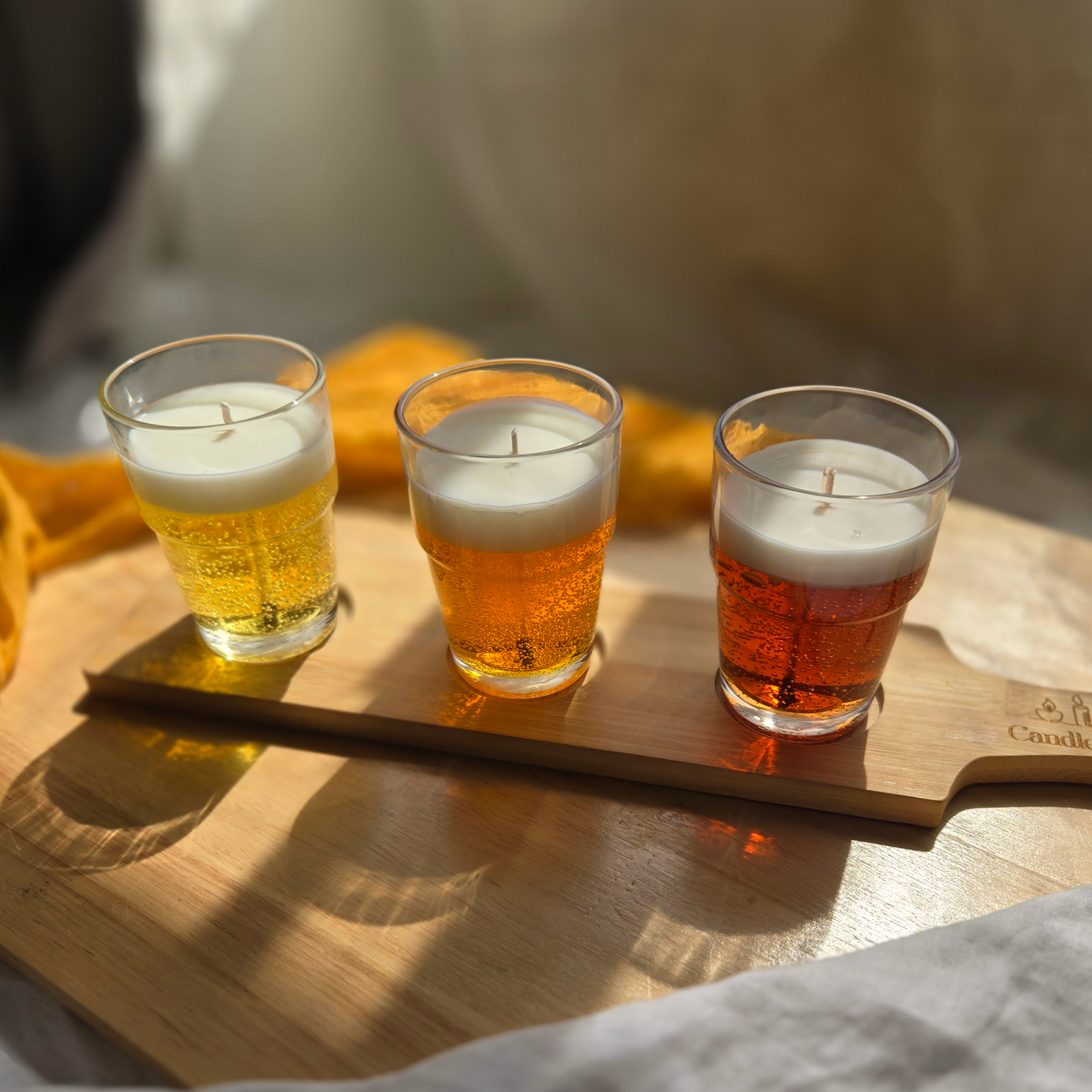 Three beer flight candles by Candle Tales on a wood tray