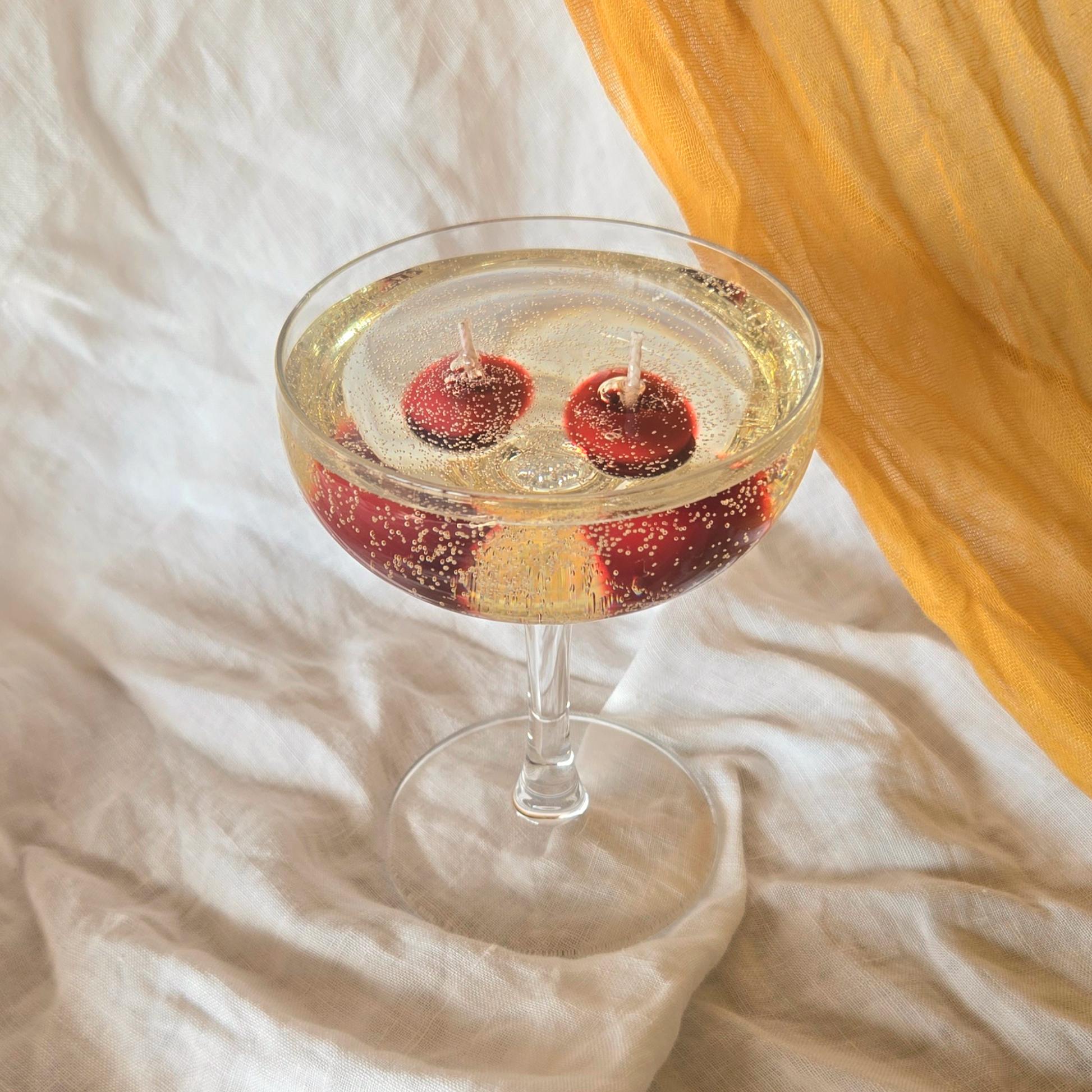 a cherry champagne gel wax candle by Candle Tales in a martini glass
