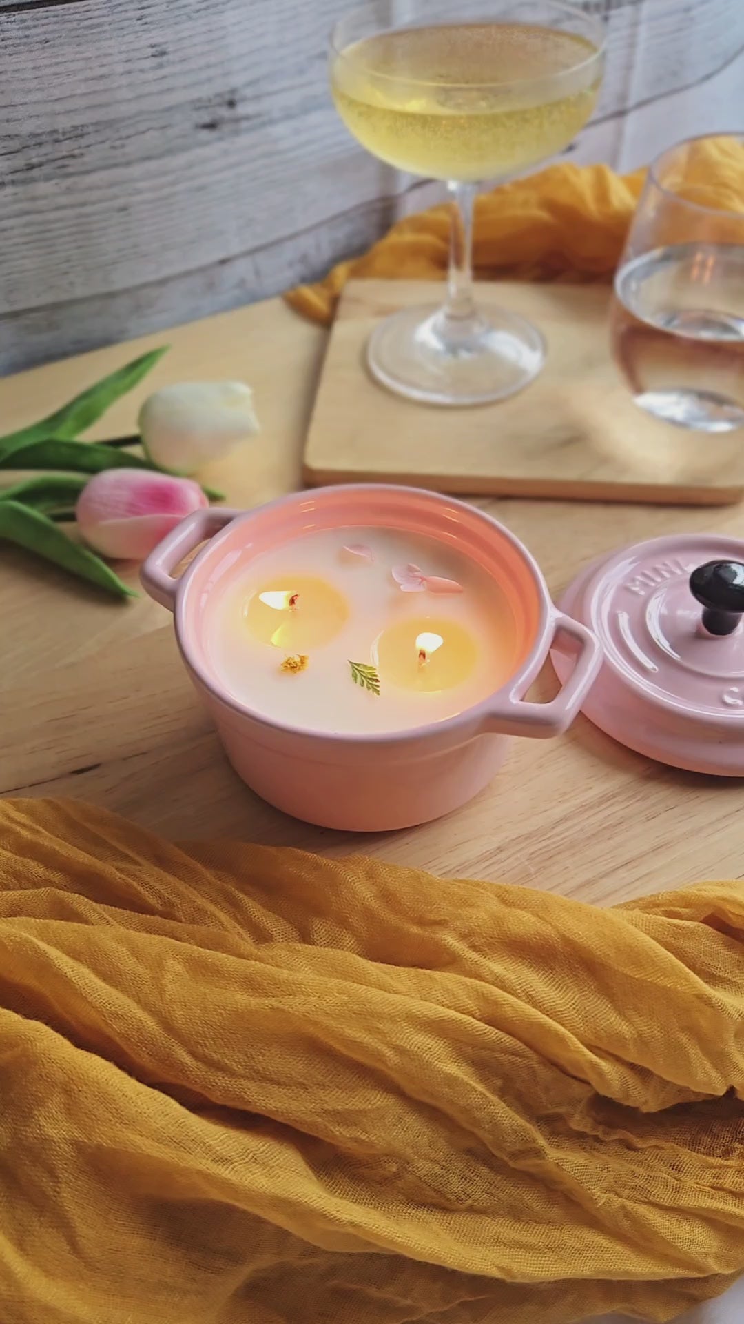 a pink soup candle by Candle Tales is lit on a dinning table
